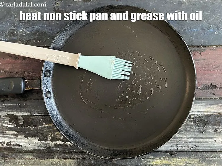 Step 33 – Heat a non-stick tava (griddle) and grease it with oil.