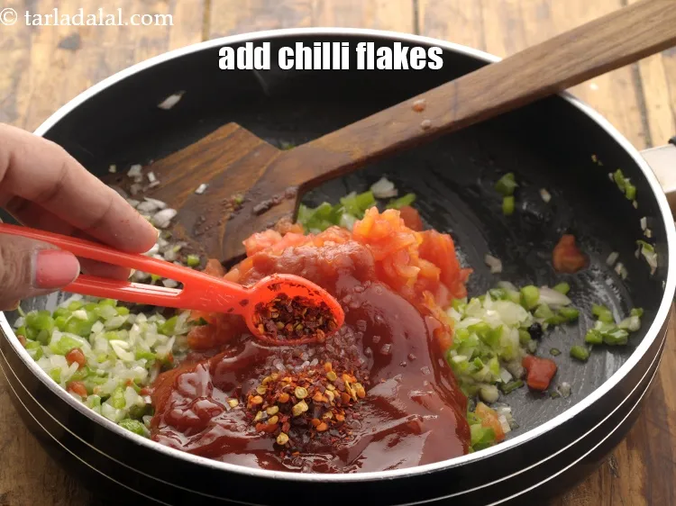 Step 14 – Add chilli flakes. It can be swapped with chili powder or paprika powder.
