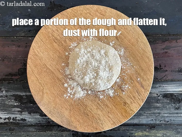 Step 17 – Place a portion of the dough on it and flatten it.