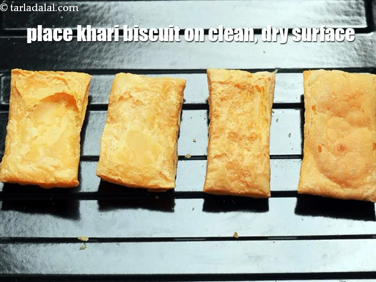 Step 15 – Place the <a href="https://www.tarladalal.com/glossary-khari-biscuit-1997i">khari biscuit</a> on a clean, dry surface.
