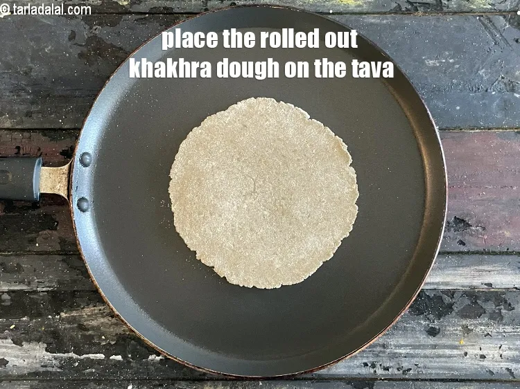 Step 16 – <meta charset="UTF-8" />Place the rolled out&nbsp;<strong>Khakhra</strong>&nbsp;dough on it.&nbsp;