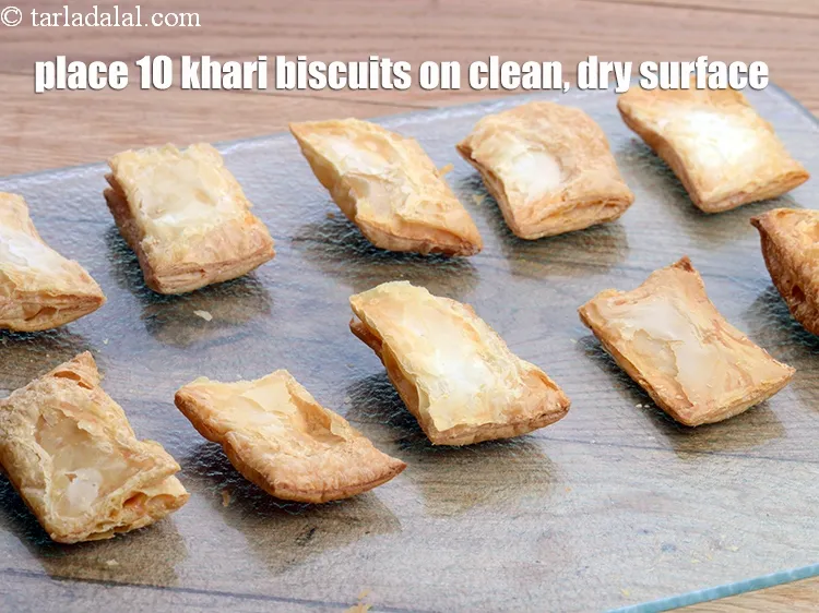 Step 15 – Place 10&nbsp;<a href="https://www.tarladalal.com/khari-biscuits-2566r">khari biscuits</a>&nbsp;on a clean, dry surface.