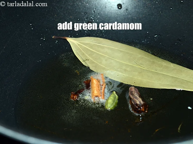 Step 15 – Add 1 green&nbsp;<a href="https://www.tarladalal.com/glossary-cardamom-elaichi-262i">cardamom (elaichi)</a>