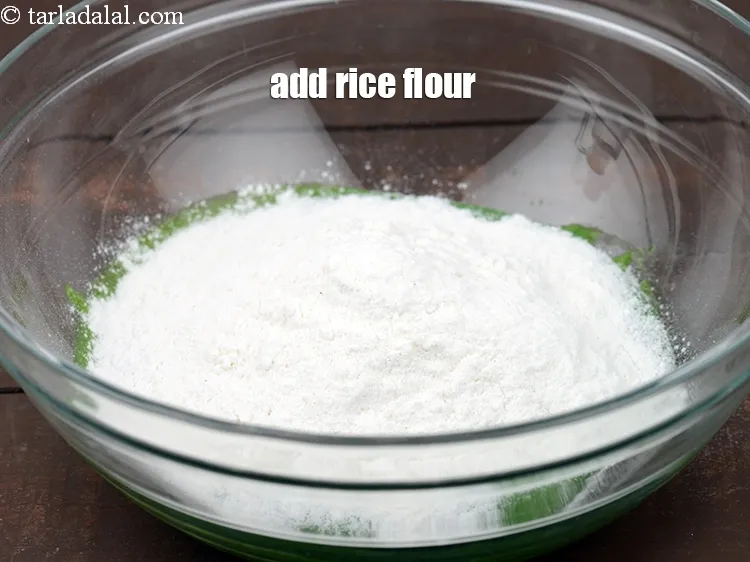 Step 15 – Add 1/2 cup&nbsp;<a href="https://www.tarladalal.com/glossary-rice-flour-chawal-ka-atta-534i">rice flour (chawal ka atta)</a>.