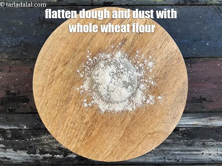 Step 18 – Flatten the dough and dust with&nbsp;whole wheat flour.