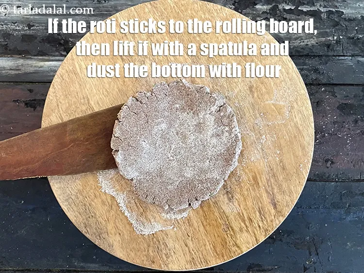 Step 32 – If the roti sticks at the bottom whole rolling, then lift the roti and put …
