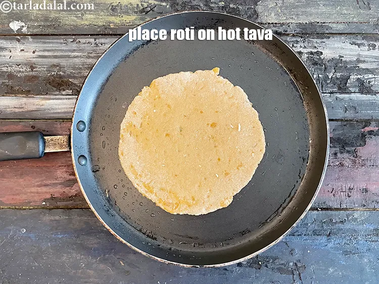 Step 16 – <meta charset="UTF-8" />Place roti on hot greased tava.&nbsp;