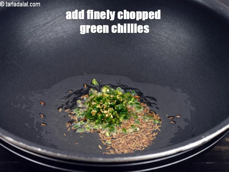 Step 15 – When they crackle, add 1 &frac12; tsp finelly&nbsp;<a href="https://www.tarladalal.com/glossary-chopped-green-chilli-820i">chopped green chillies</a>.&nbsp;