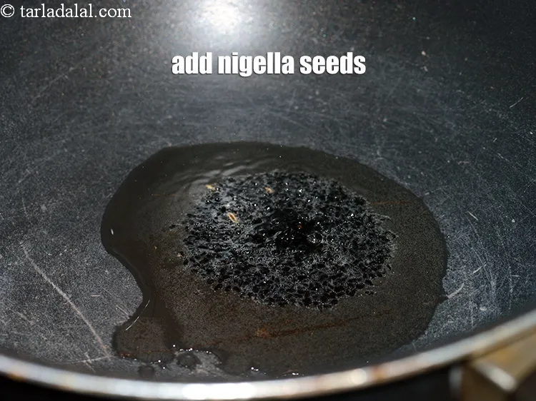 Step 16 – Add &frac12; tsp <a href="https://www.tarladalal.com/glossary-nigella-seeds-kalonji-onion-seeds-552i">nigella seeds (kalonji)</a>.