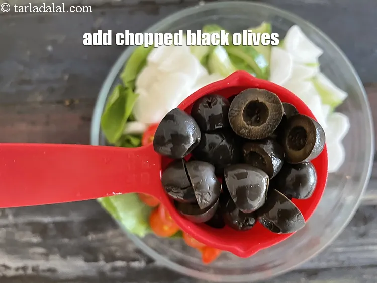 Step 27 – Add&nbsp;<meta charset="UTF-8" />1/4 cup&nbsp;<a href="glossary-chopped-black-olives-1021i">chopped black olives</a>.
