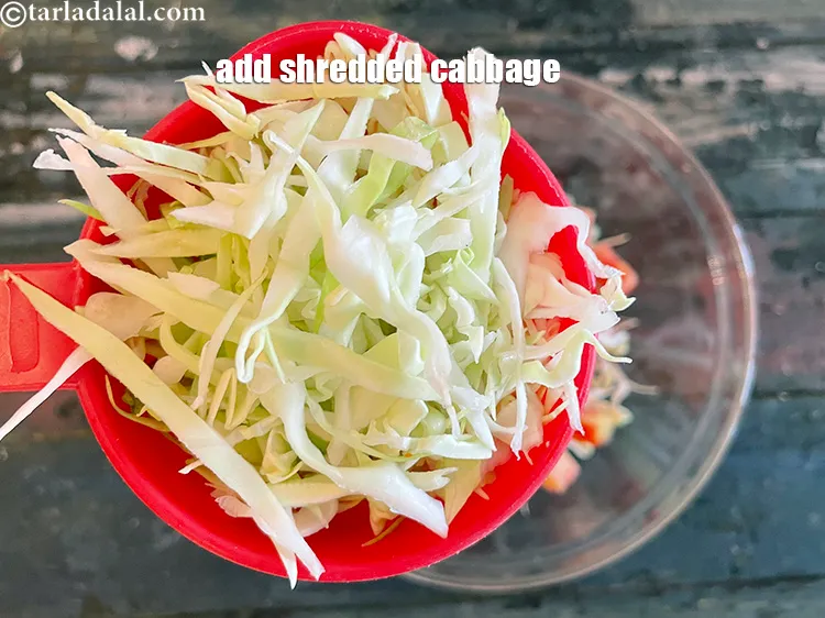 Step 21 – Add&nbsp;<meta charset="UTF-8" />2 cups&nbsp;<a href="glossary-shredded-cabbage-763i">shredded cabbage</a>.