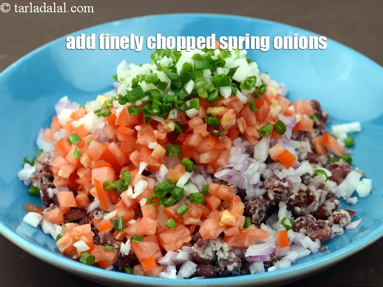 Step 15 – Add 1/4 cup finely <a href="https://www.tarladalal.com/glossary-chopped-spring-onions-1575i">chopped spring onions</a>.