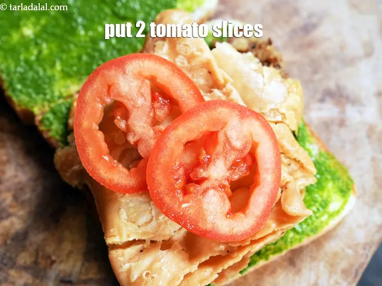 Step 17 – Arrange 2 <a href="https://www.tarladalal.com/glossary-tomato-slices-1823i">tomato slices</a>.&nbsp;