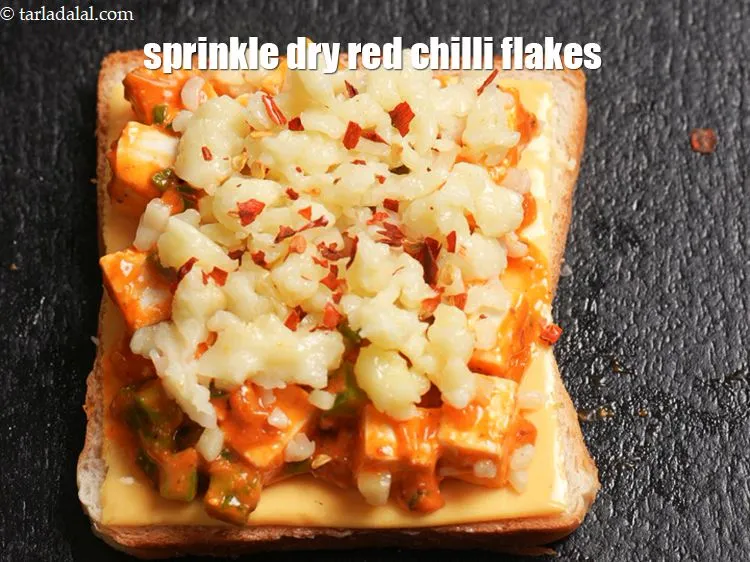 Step 15 – Sprinkle &frac14; tsp <a href="https://www.tarladalal.com/glossary-dry-red-chilli-flakes-paprika-338i">dry red chilli flakes (paprika)</a>.