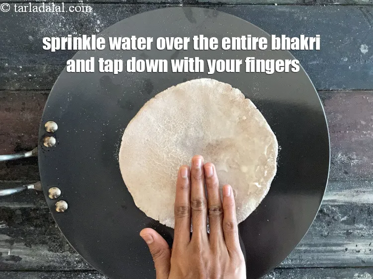 Step 17 – Sprinkle water on the top of the entire bhakri.