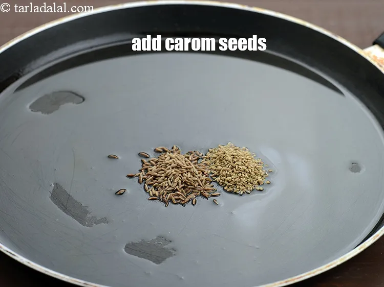Step 15 – Add &frac12; tsp <a href="https://tarladalal.com/glossary-carom-seeds-ajwain-thymol-seeds-bishops-weed-266i">carom seeds (ajwain)</a>.