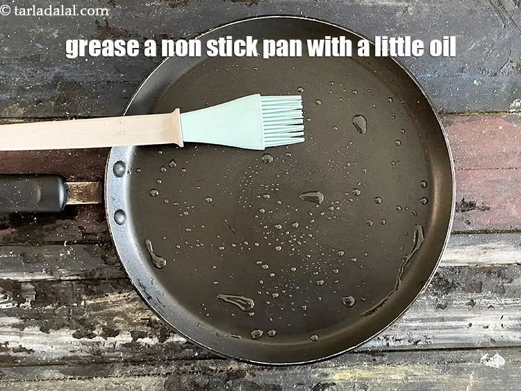 Step 15 – Grease a hot non stick tava (griddle) with a little oil. &nbsp;