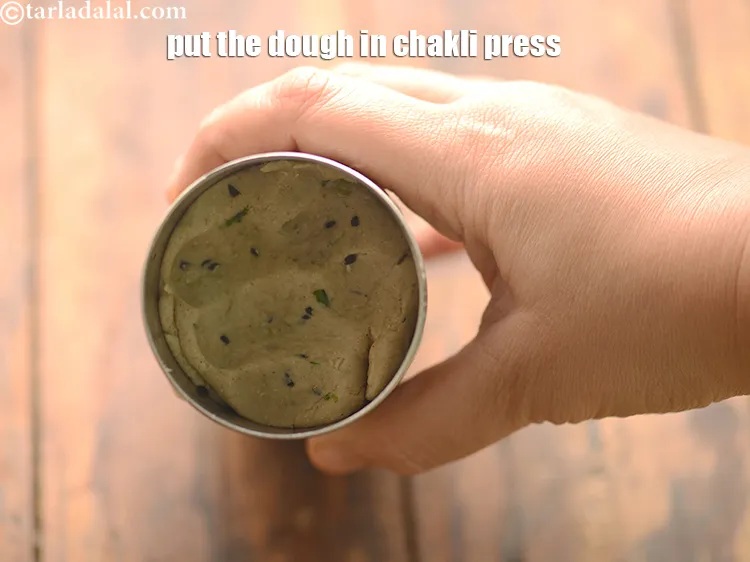 Step 29 – Put the dough in the greased chakli mould.