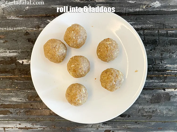 Step 20 – Shape each portion into a round laddoo by rolling them in between your palms.
