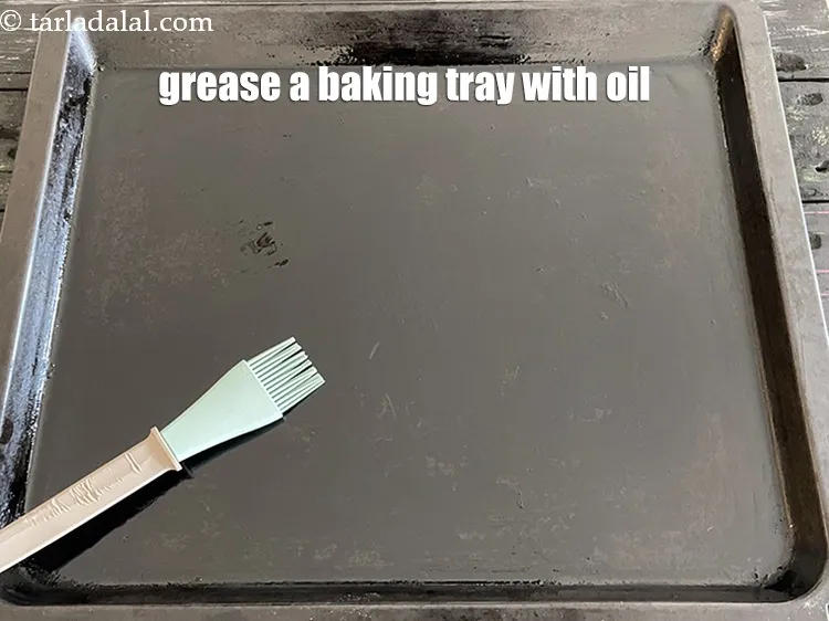 Step 16 – Grease a baking tray with oil using a brush.&nbsp;