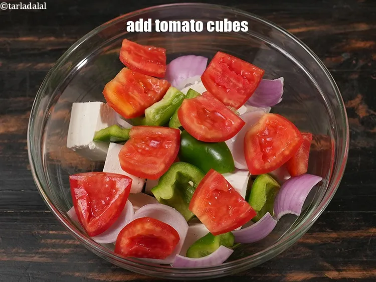 Step 16 – Add&nbsp;1/2 cup&nbsp;<a href="https://www.tarladalal.com/glossary-tomato-cubes-728i">tomato cubes</a>.