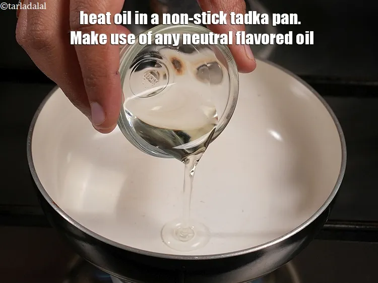 Step 16 – For the tempering of nariyal ki chutney, heat oil in a non-stick tadka pan. Make …