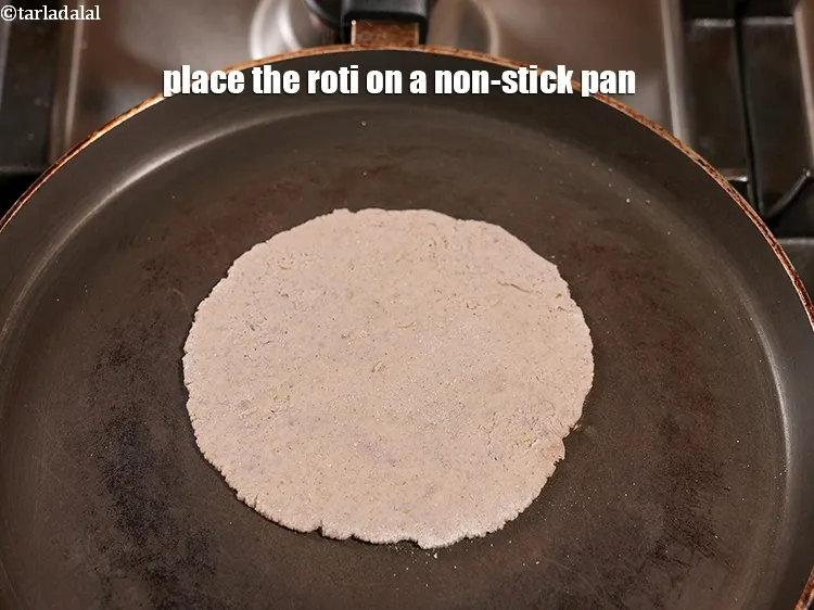 Step 17 – <p>Place the rolled roti on a hot tava.</p>