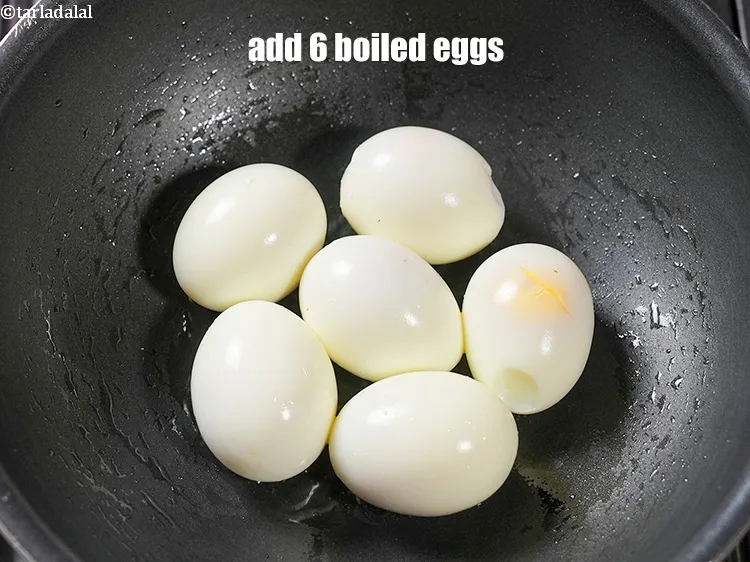 Step 16 – Add 6 <a href="https://www.tarladalal.com/glossary-boiled-eggs-2369i">boiled eggs</a>.