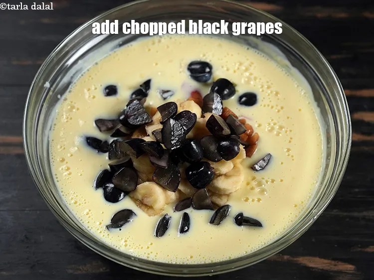 Step 16 – Add &frac12; cup <a href="https://www.tarladalal.com/glossary-chopped-black-grapes-1071i">chopped black grapes</a>.