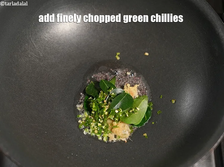 Step 16 – Add 2 tsp finely <a href="https://www.tarladalal.com/glossary-chopped-green-chilli-820i">chopped green chillies</a>.&nbsp;