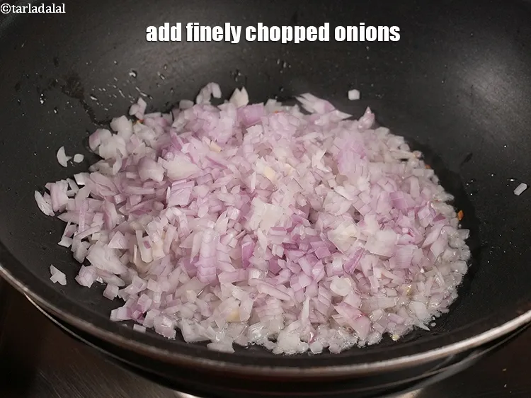Step 16 – Add 1 cup finely <a href="https://www.tarladalal.com/glossary-chopped-onions-722i">chopped onions</a>.