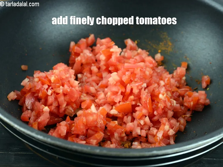 Step 16 – Add 1 cup finely <a href="https://www.tarladalal.com/glossary-chopped-tomatoes-779i">chopped tomatoes</a>.