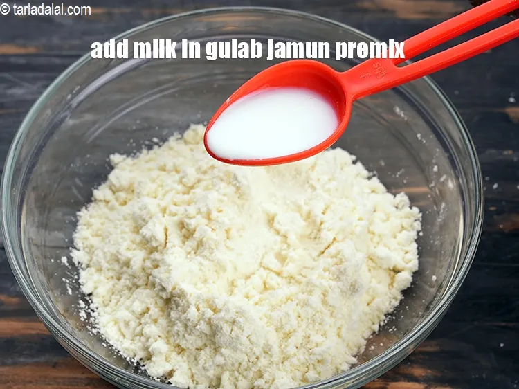 Step 17 – To make <strong>instant gulab jamun</strong>, add 5 tbsp of milk in the gulab jamun premix.