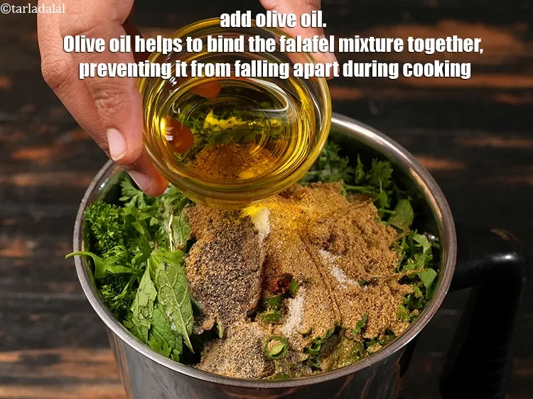 Step 16 – Add 2 tbsp <a href="https://www.tarladalal.com/glossary-olive-oil-451i">olive oil</a>. Olive oil helps to bind the falafel mixture together, …