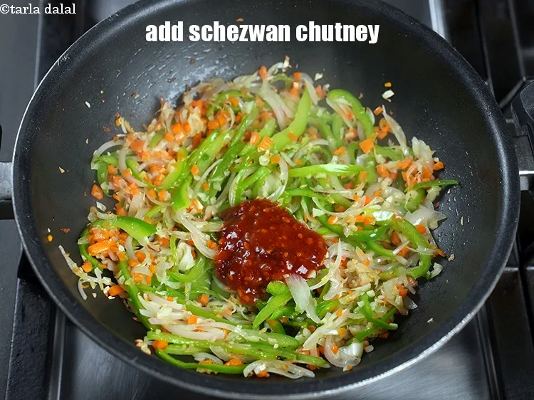 Step 21 – Add 2 tbsp <a href="https://www.tarladalal.com/glossary-schezwan-sauce-schezuan-sauce-1872i">schezwan chutney</a>.