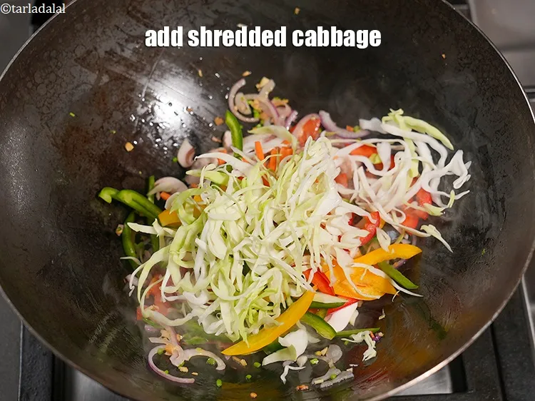Step 19 – Add &frac12; cup&nbsp;<a href="https://www.tarladalal.com/glossary-shredded-cabbage-763i">shredded cabbage</a>.