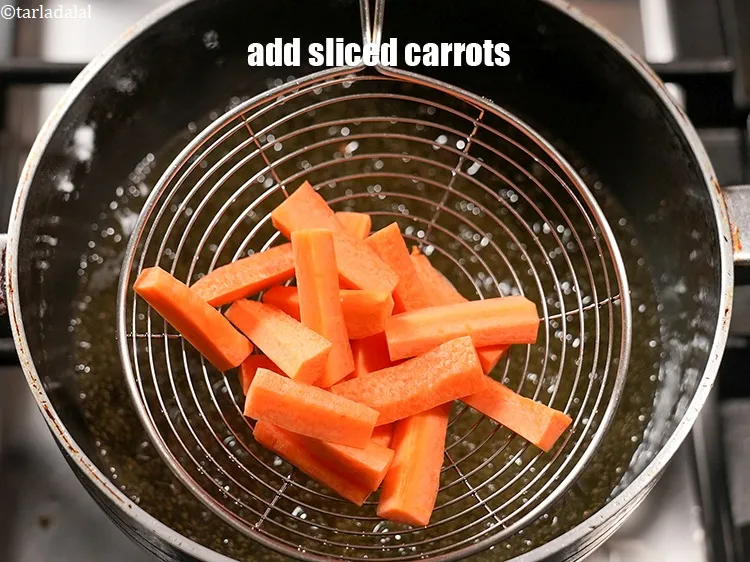 Step 17 – In the same oil add &frac12; cup <a href="https://www.tarladalal.com/glossary-sliced-carrots-748i">sliced carrots</a>.