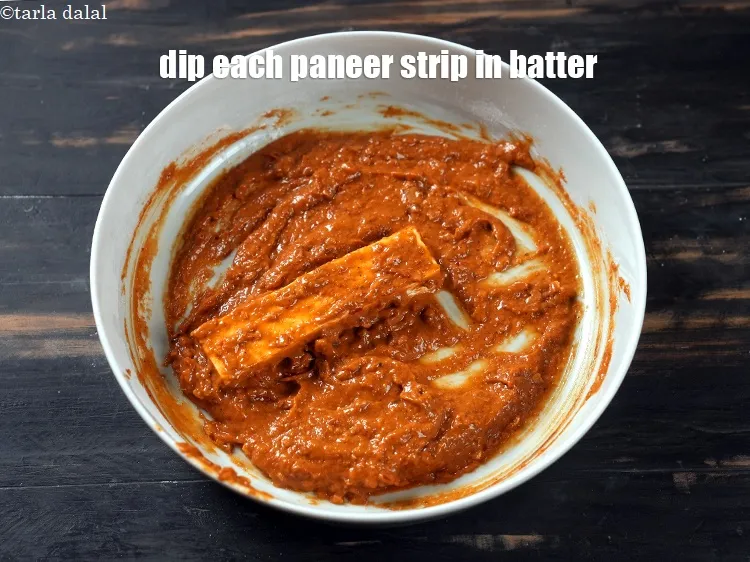 Step 16 – Dip each paneer strip in the prepared batter.