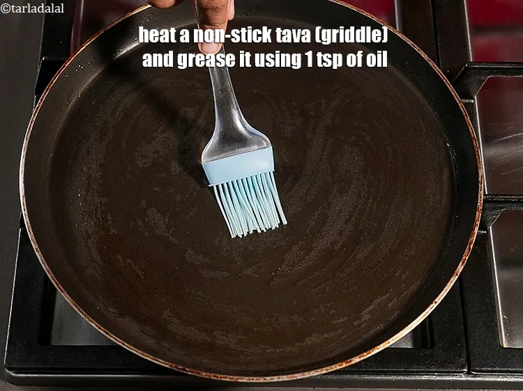 Step 16 – Heat a non-stick tava (griddle) and grease it using 1 tsp of oil.