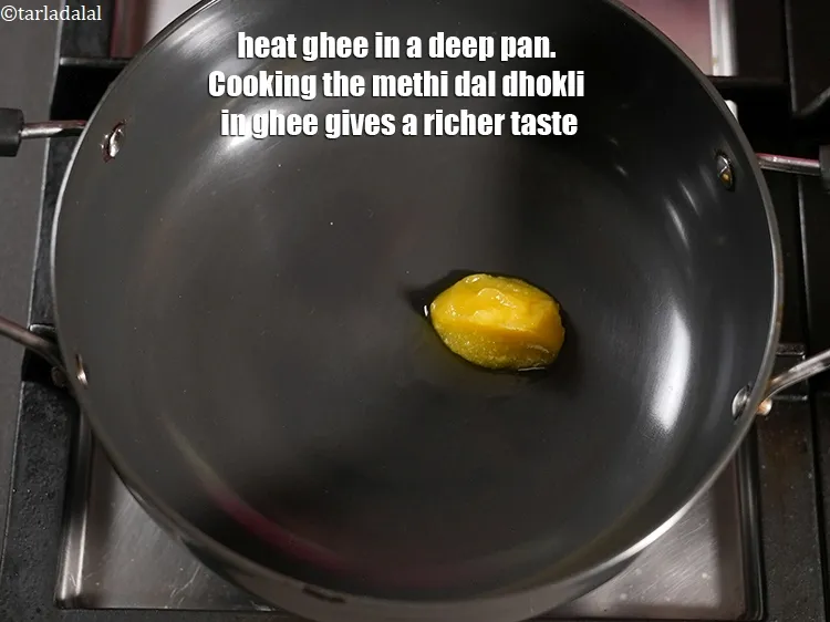 Step 16 – Heat 2 tsp <a href="https://www.tarladalal.com/glossary-ghee-245i">ghee</a> in a deep pan. Cooking the methi dal dhokli in …