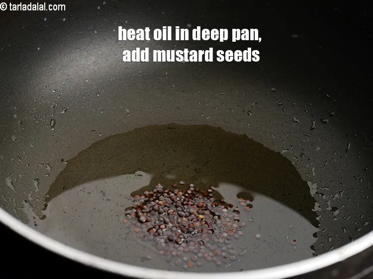 Step 18 – Heat the oil in a deep non-stick pan, add the remaining &frac12; tsp mustard seeds.