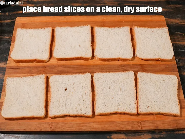 Step 16 – Place 8 <a href="https://www.tarladalal.com/glossary-bread-219i">bread</a>&nbsp;slices on a clean, dry surface.