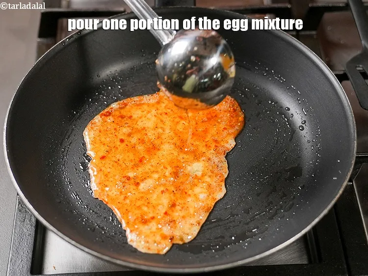 Step 16 – Pour one portion of the egg mixture.