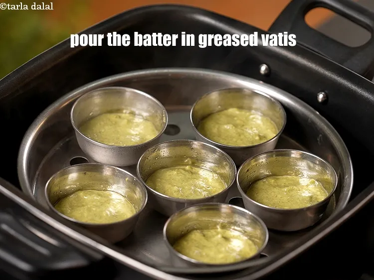 Step 16 – Pour 1 tbsp of batter in each of the 6 greased vatis.&nbsp;