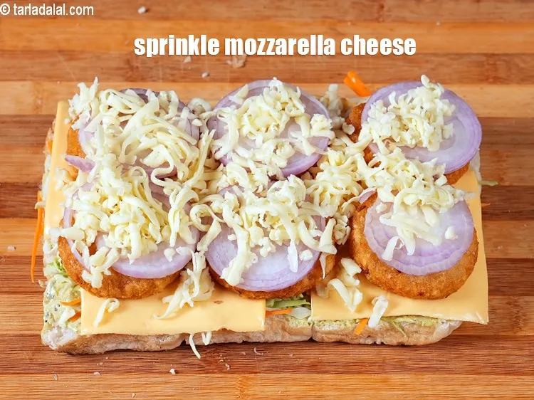 Step 19 – Sprinkle &frac12; cup&nbsp;<a href="https://www.tarladalal.com/glossary-diced-mozzarella-cheese-2805i">diced mozzarella cheese</a>.