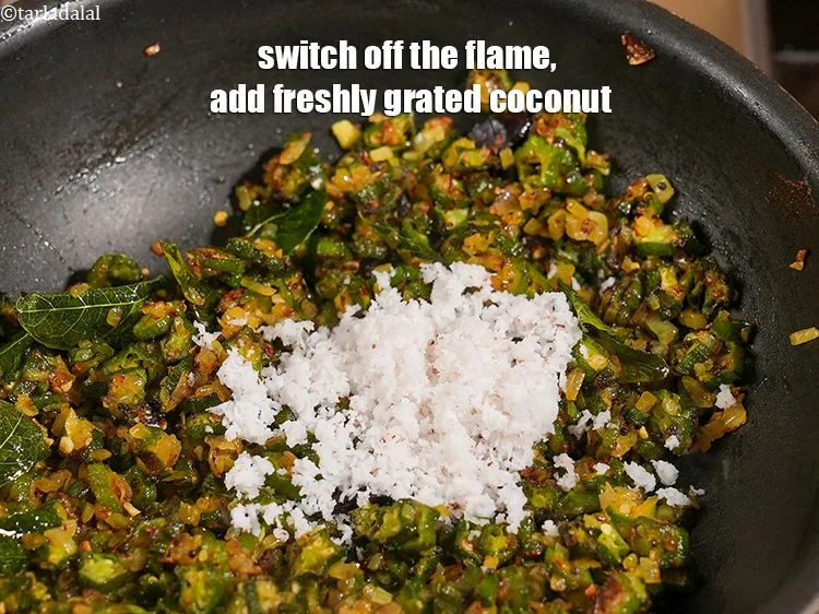 Step 16 – Switch off the flame, add &frac14; cup freshly <a href="https://www.tarladalal.com/glossary-grated-coconut-852i">grated coconut</a>.