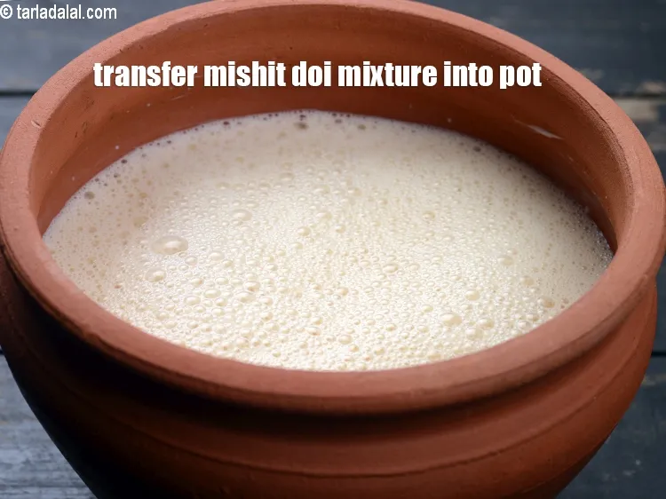 Step 16 – Now transfer the mishit doi mixture into an earthen pot.