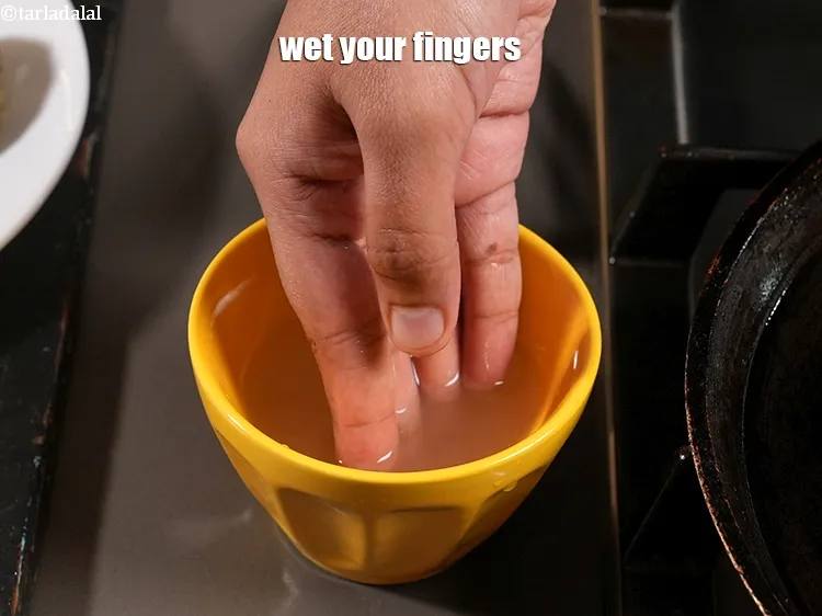 Step 15 – <meta charset="UTF-8" /> Wet your fingers, place a portion of the dough on a hot …