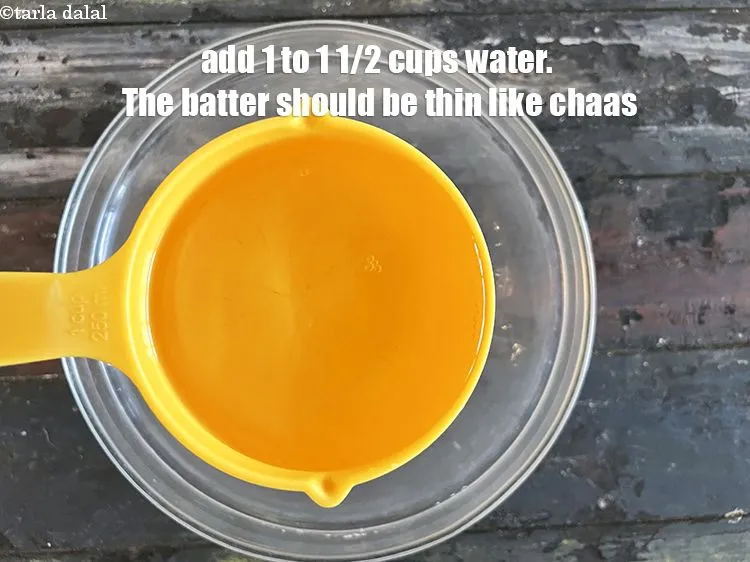 Step 16 – Add 1 cup to 1 1/2 cups water.&nbsp;The batter should be like thin chaas.