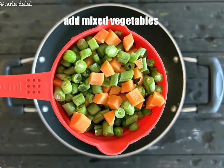 Step 22 – <html><head></head><body><p>Add&nbsp;3/4 cup&nbsp;<a href="glossary-mixed-vegetables-mixed-sabzi-723i">mixed vegetables</a>.</p></body></html>